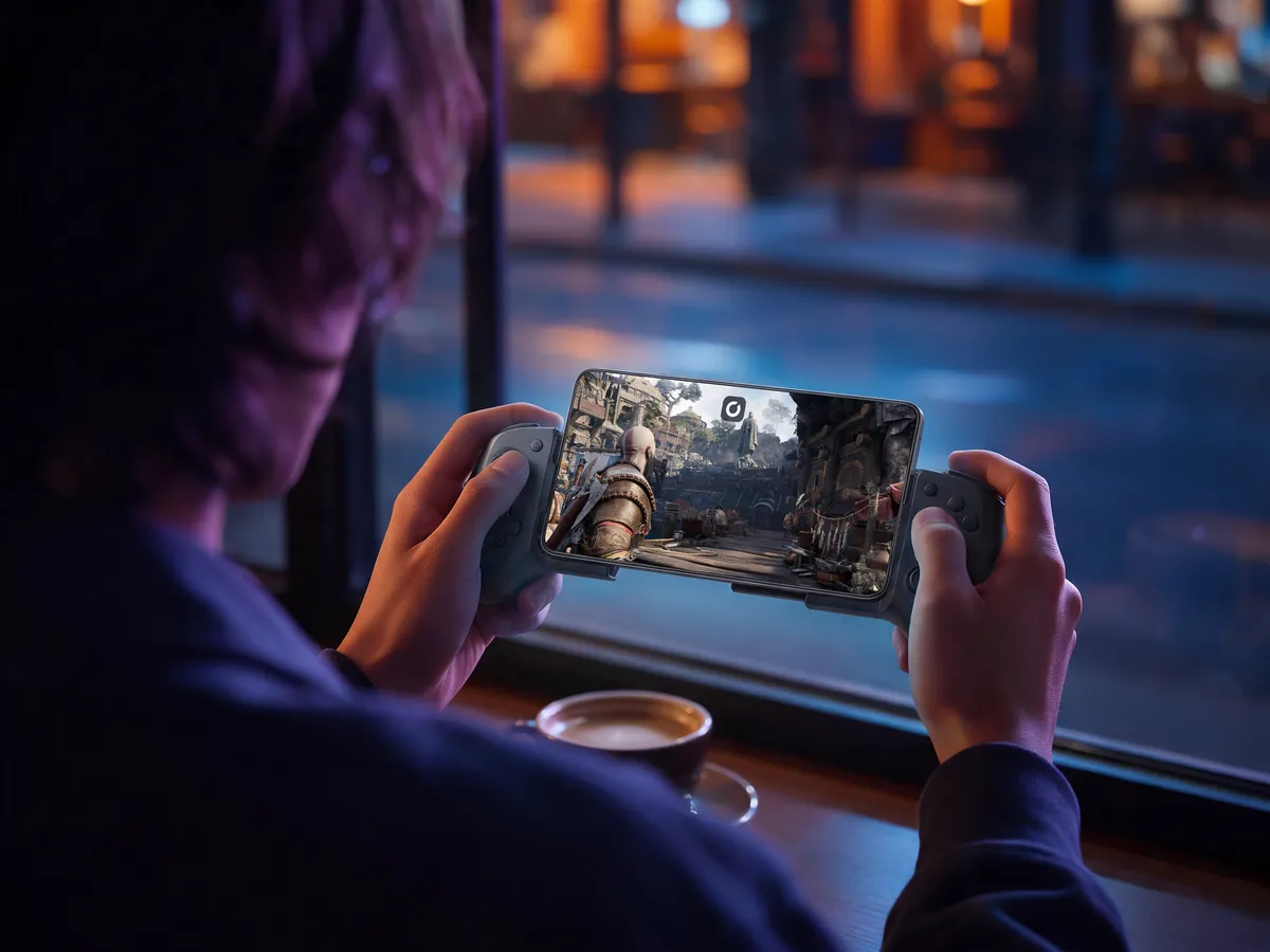 God of War on an Android phone in a controller at a café window